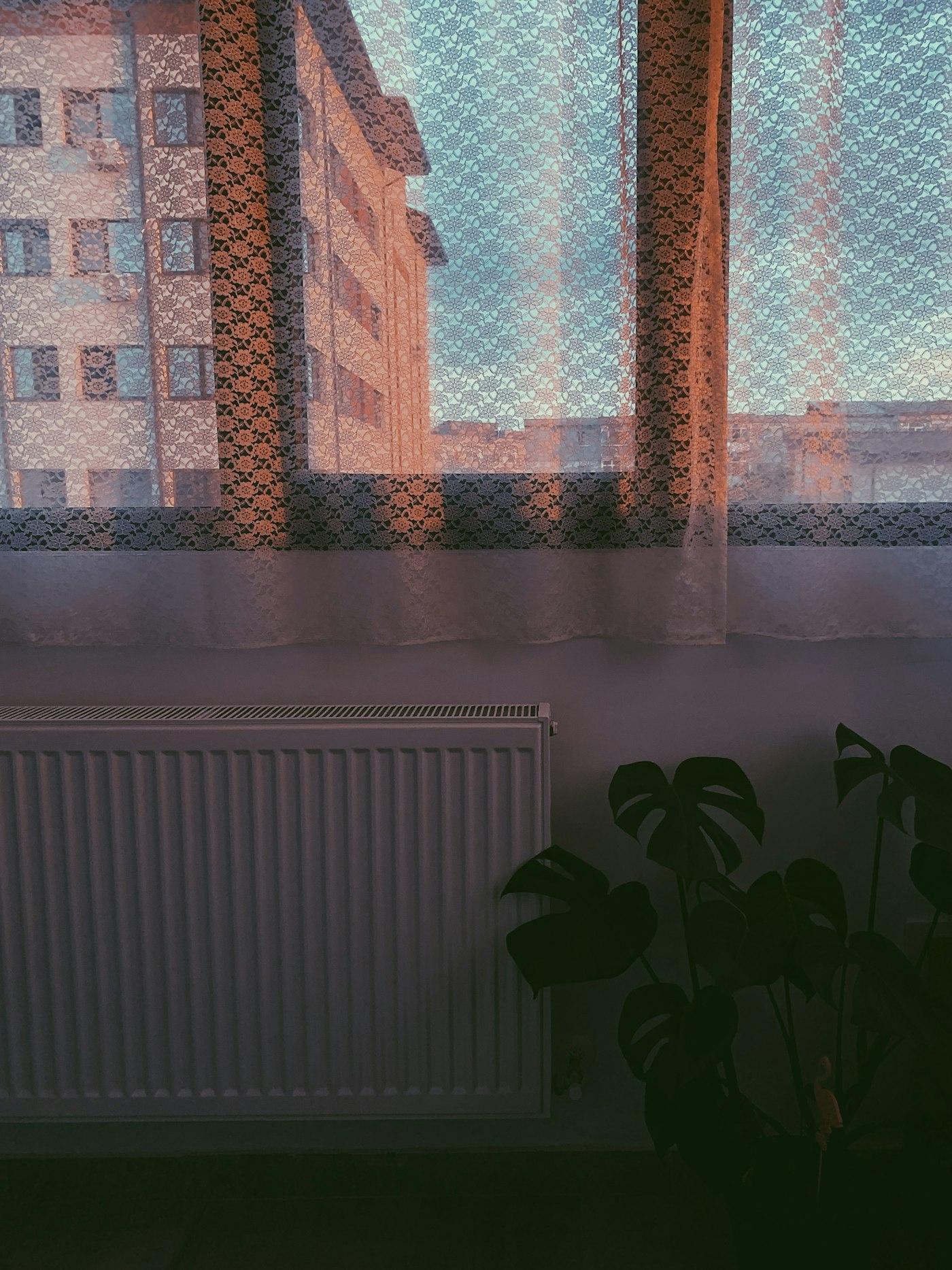 Radiateur blanc près d’une fenêtre, confort chauffage